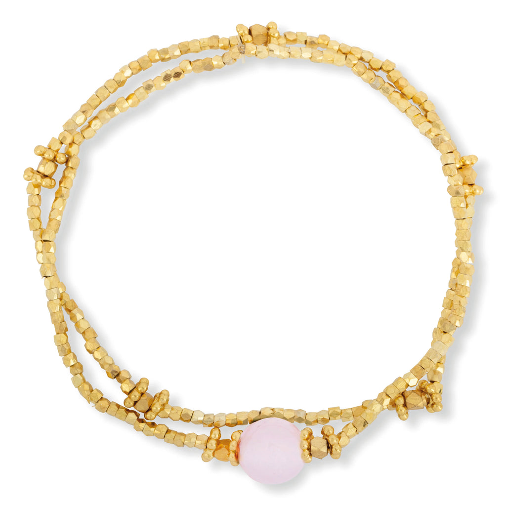 Pair of gold stretch bracelets with faceted gold beads and polished Rose Quartz bead. 
Ashiana London Bluebell Rose Quartz Bracelet - Jo And Co Ashiana London Bluebell Rose Quartz Bracelet - Ashiana London