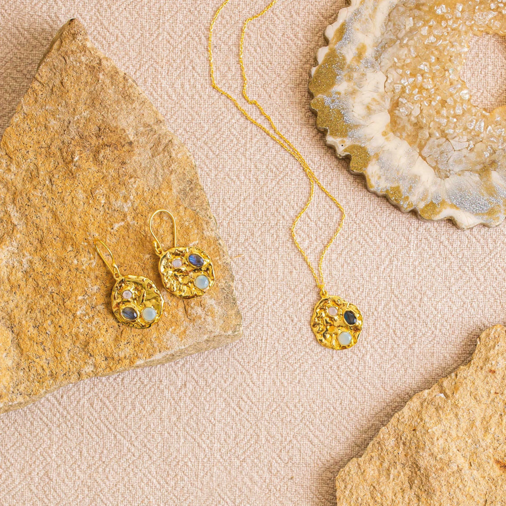 Gold coin earrings with three inset gemstones of aqua chalcedony, rainbow moonstone, and labradorite.
Ashiana London Rhode Gemstone Coin Earrings - Jo And Co Ashiana London Rhode Gemstone Coin Earrings - Ashiana London