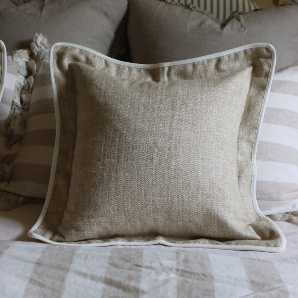 Beige herringbone cushion with white trim.
Beige Herringbone Tia Cushion - Jo And Co Beige Herringbone Tia Cushion