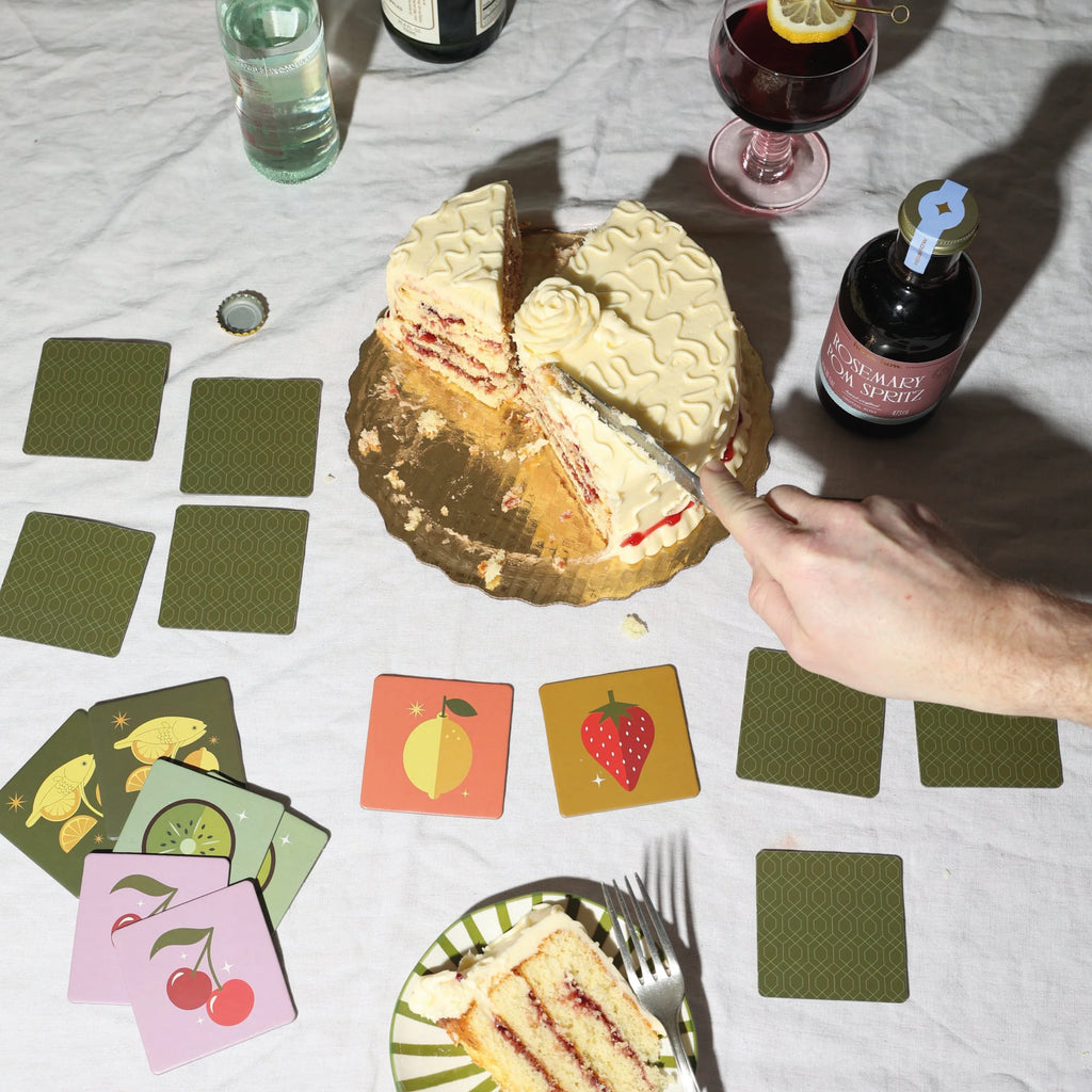 Memory game packaging with cocktail illustration on a green and pink box.
Cocktail Memory Game - Jo And Co Cocktail Memory Game - Designworks Ink