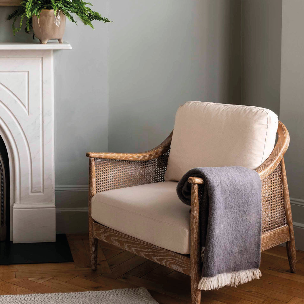 Rolled-up grey throw blanket with white fringe in 100% New Zealand wool.
Grey Wool Leigh Reversible Throw - Jo And Co Grey Wool Leigh Reversible Throw