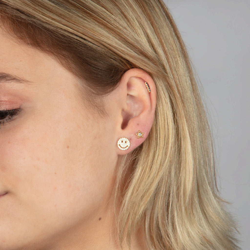 Gold smiley face earrings with clear gemstones.
Happy Days Studs - Jo And Co Happy Days Studs