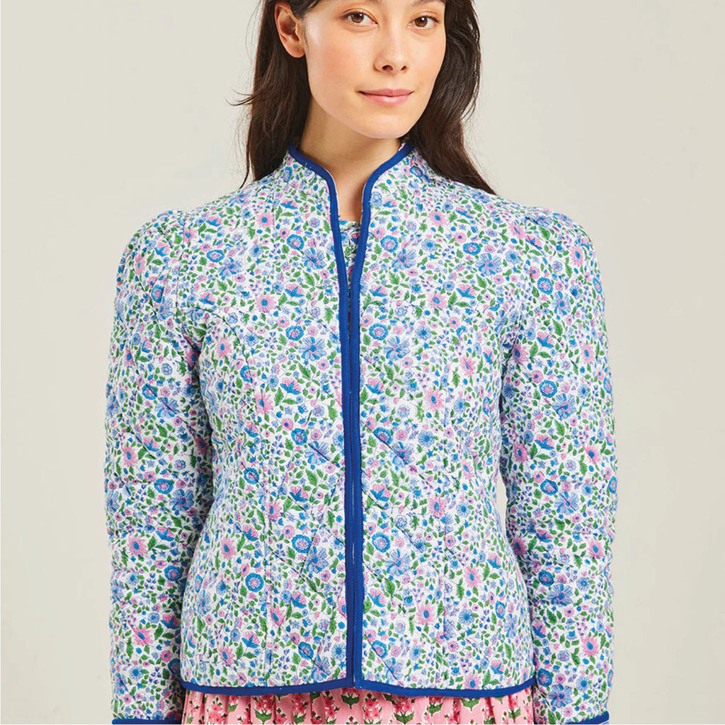 Jo And Co Pink City Prints Sky Meadow Frankie Jacket_Perfect for layering in the cool of the evening, our Sky Meadow Frankie jacket is a must-have this Spring. Block-printed by hand in soft shades of blue, lilac and green, the Frankie jacket is finished with statement solid blue piping, gently gathered sleeves and side seam pockets for everyday wear. Made from cosy, quilted cotton to keep you warm. Finished with contrasting Sky Magnolia lining.