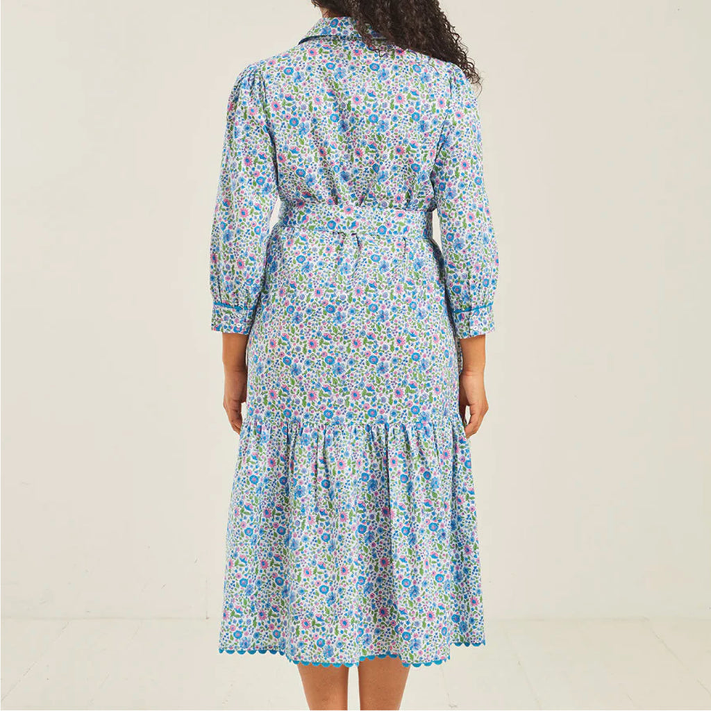 Jo And Co Pink City Prints Sky Meadow Margot Dress_Block-printed by hand in our pretty, new Sky Meadow ditsy, the Margot dress is a flattering and versatile wardrobe favourite. Finished with a pretty, blue ric-rac trim, the Margot dress features a neat collar and placket, relaxed, waistless fit and full length sleeves with a ricrac trimmed cuffed. Wear loose for an effortless look, or cinch in your waist with the matching belt to dress up the Margot for special occasions.