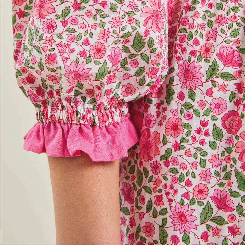 Jo And Co Pink City Prints Hollyhock Meadow Tilly Dress_Finished with a pretty, pink solid frill and covered buttons, our bestselling Tilly dress is a versatile addition to your wardrobe. Block-printed by hand in our pretty, new Hollyhock Meadow ditsy, the Tilly dress has a gently fitted waist, button down placket and gathered, pin-tucked skirt. Dress up with heeled boots, or throw on everyday with trainers.