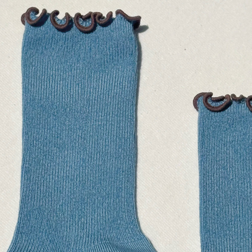 Blue socks with ruffled brown top.
Le Bon Shoppe Ruffled Modal Powder Blue Socks - Jo And Co Le Bon Shoppe Ruffled Modal Powder Blue Socks - Le Bon Shoppe
