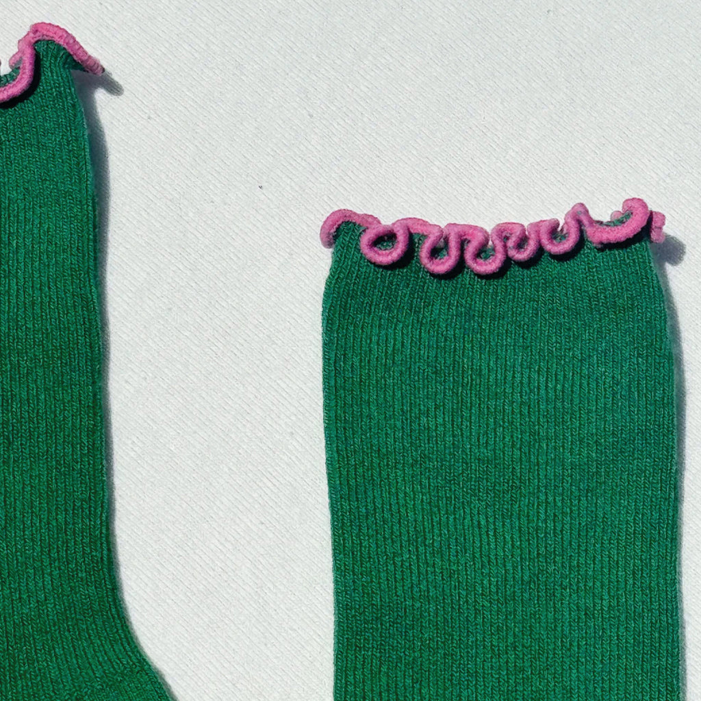 Green sock with pink ruffled trim.
Le Bon Shoppe Ruffled Modal Spinach Socks - Jo And Co Le Bon Shoppe Ruffled Modal Spinach Socks - Le Bon Shoppe