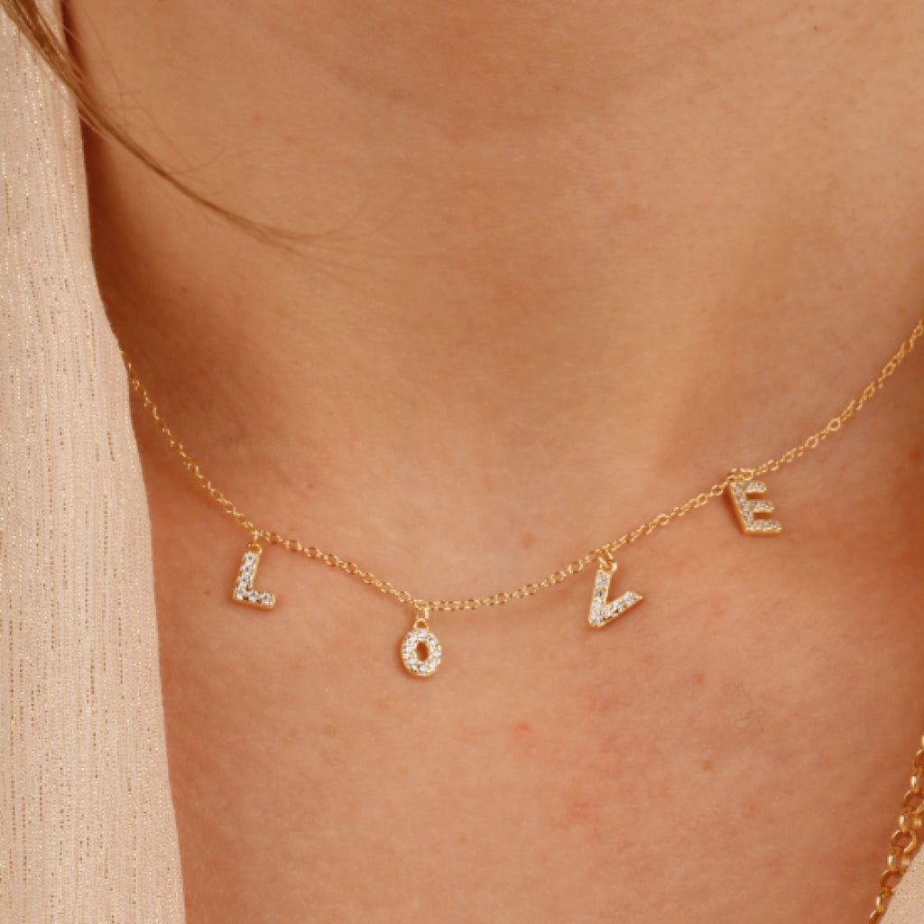 Gold chain necklace with L O V E pendants with white stones.
Love Letter Pendant - Jo And Co Love Letter Pendant