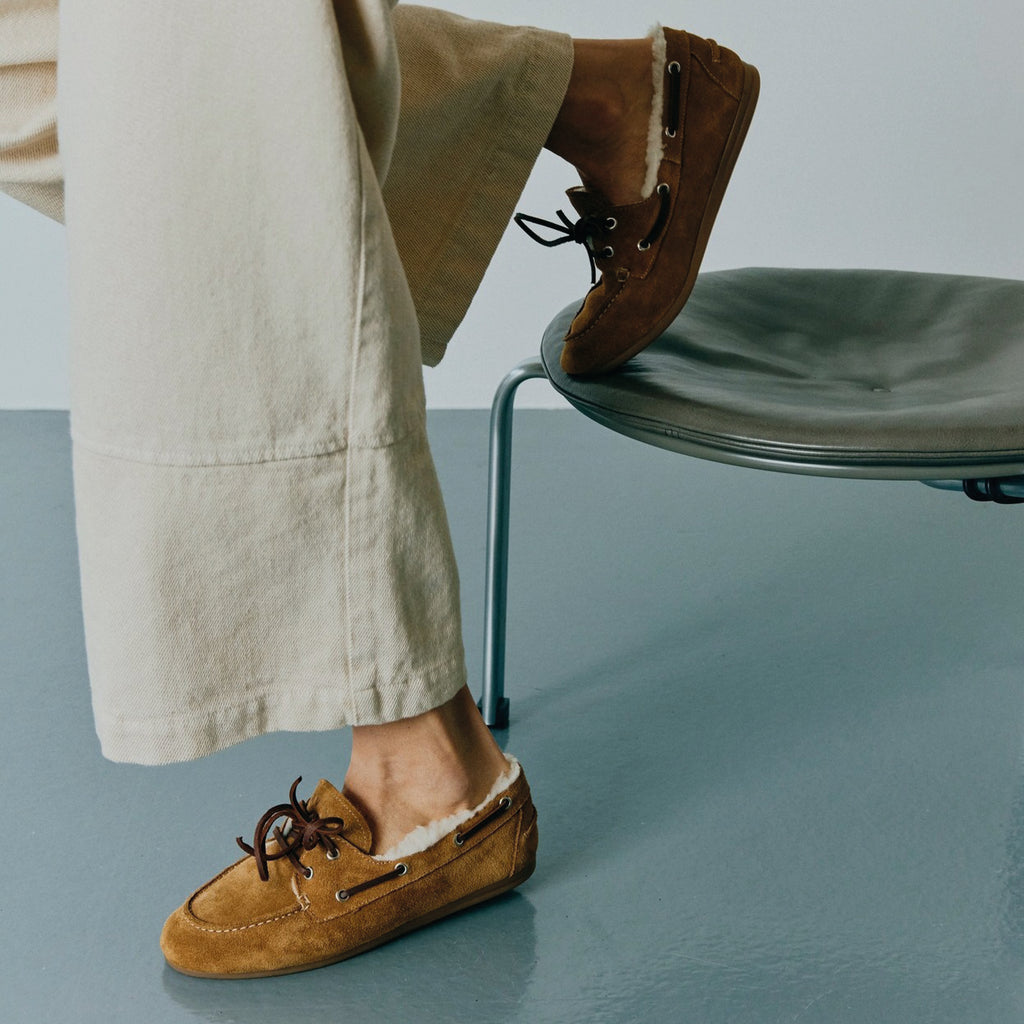 Pair of brown suede shoes with white fur lining on a white background.
Pavement Tan Suede Vilde Loafers - Jo And Co Pavement Tan Suede Vilde Loafers - Pavement