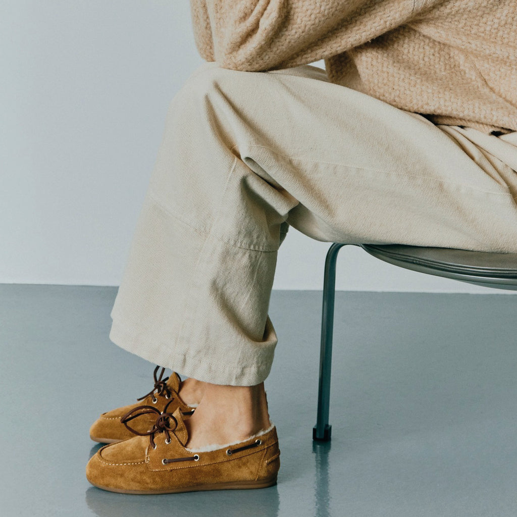 Pair of brown suede shoes with white fur lining on a white background.
Pavement Tan Suede Vilde Loafers - Jo And Co Pavement Tan Suede Vilde Loafers - Pavement