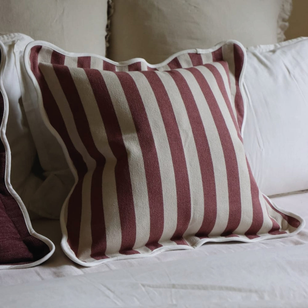 Striped pillow with plum purple and white stripes and white scalloped edge.
Plum Stripe Scalloped Chloe Cushion - Jo And Co Plum Stripe Scalloped Chloe Cushion