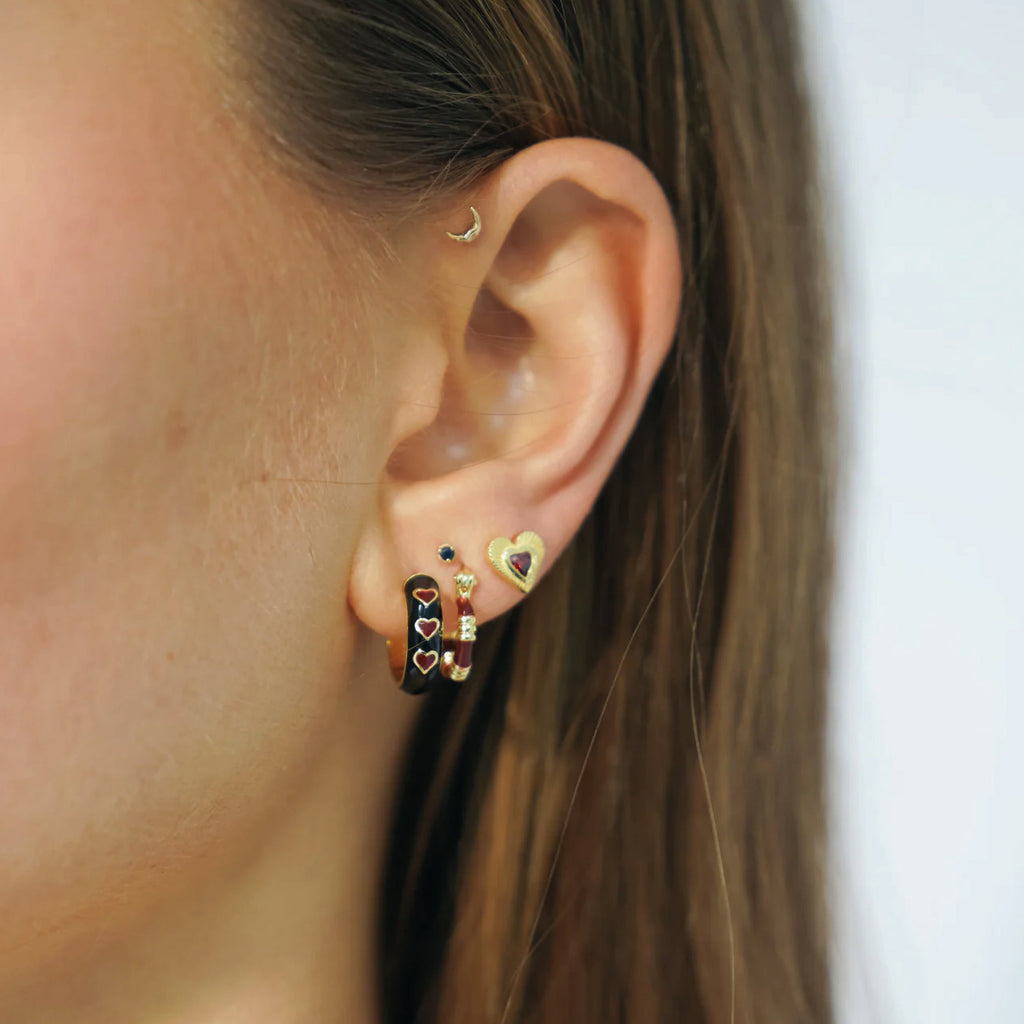 Gold heart-shaped earrings with a red gemstone.
Rhapsody Love Stud Gold Plated Earrings - Jo And Co Rhapsody Love Stud Gold Plated Earrings - Anna + Nina