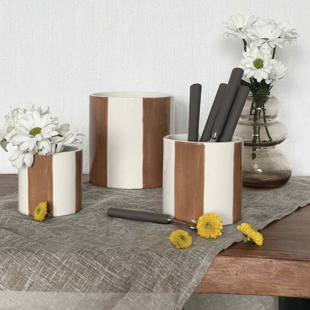 Set of four cylindrical ceramic planters with brown striped design.
Set of 4 Brown Pots - Jo And Co Set of 4 Brown Pots