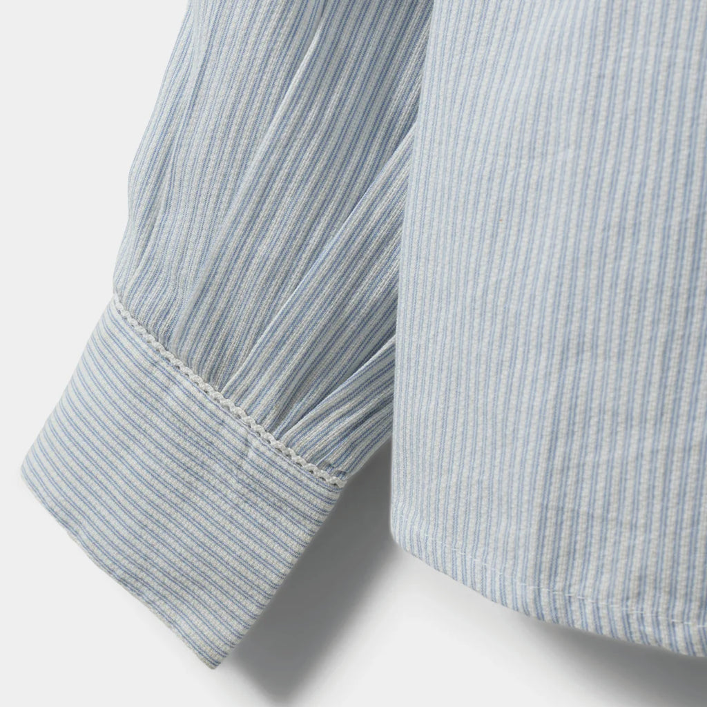 Light blue striped shirt with frilled collar with decorative edge along button placket and wrinkle details on shoulders.
Sofie Schnoor Light Blue Striped Edna Shirt - Jo And Co Sofie Schnoor Light Blue Striped Edna Shirt - Sofie Schnoor