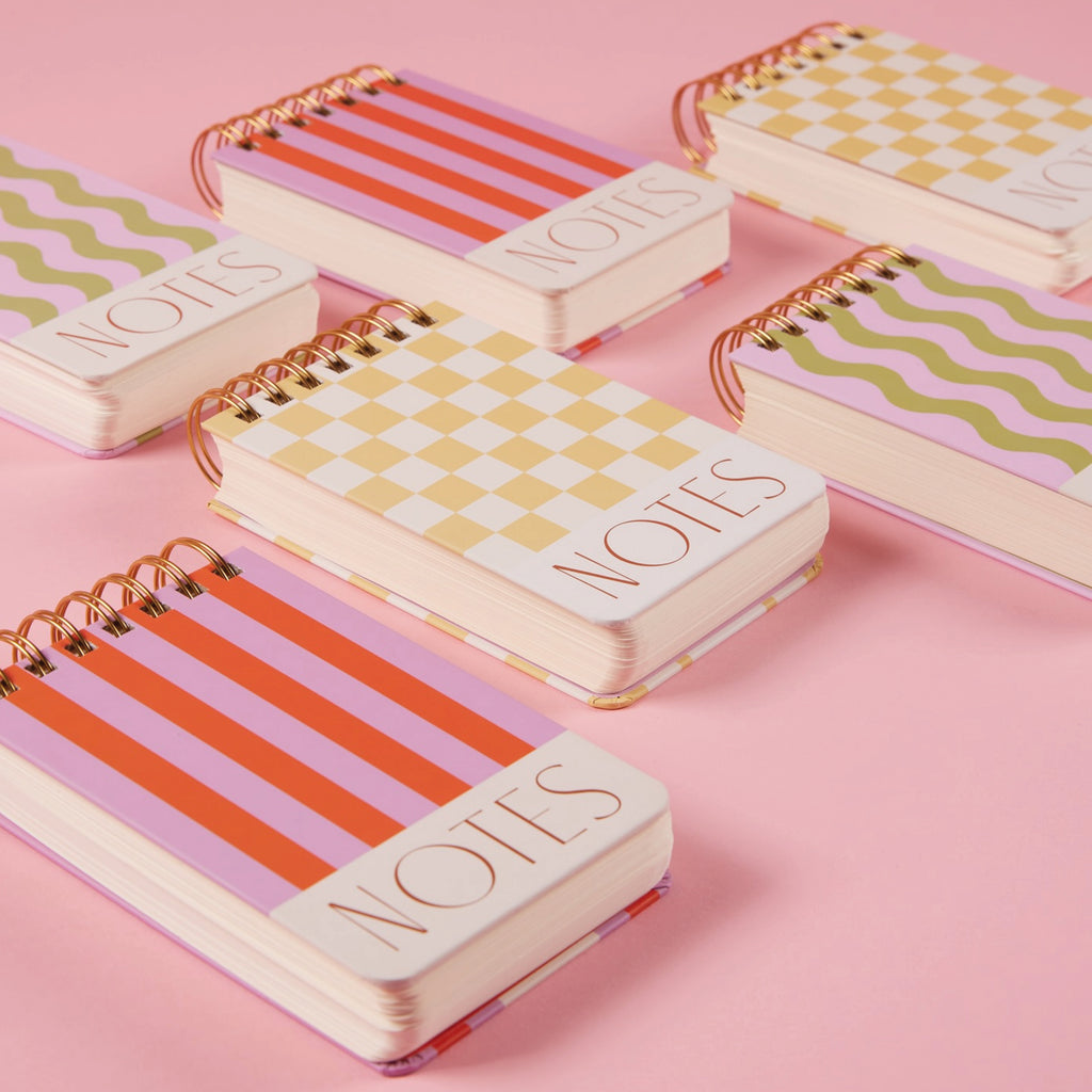 Mini chunky notepad with pink and green wave print and gold foil accent 'NOTES' on front cover. 
Wavy Striped Chunky Notepad - Jo And Co Wavy Striped Chunky Notepad - Designworks Ink
