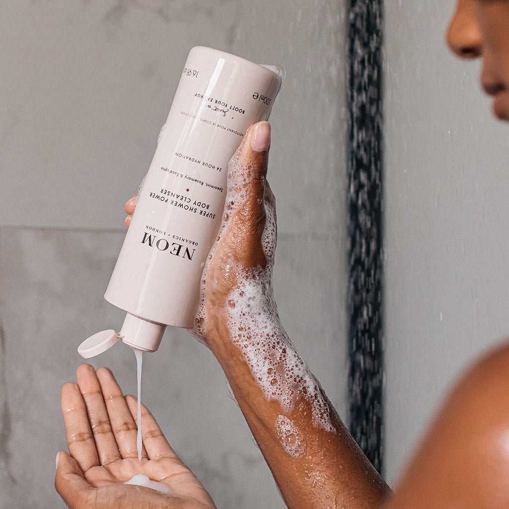 NEOM Super Shower Power Body Cleanser 500ml being used in shower for skin hydration and energy boost.
